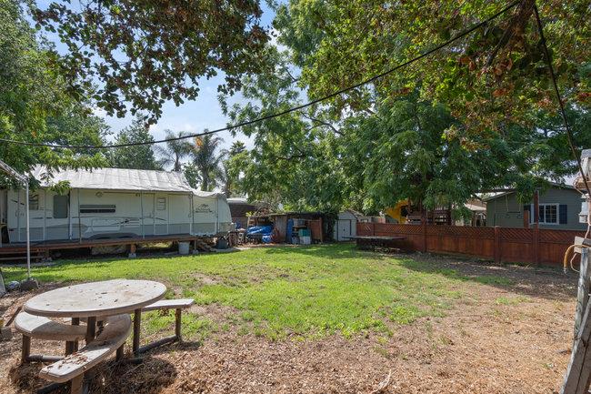 22 Heiner Road Watsonville, CA 95076 - Photo 49 of 51 a view of a backyard with table and chairs under an umbrella
