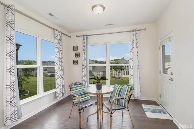 a view of a dining room with furniture window and wooden floor