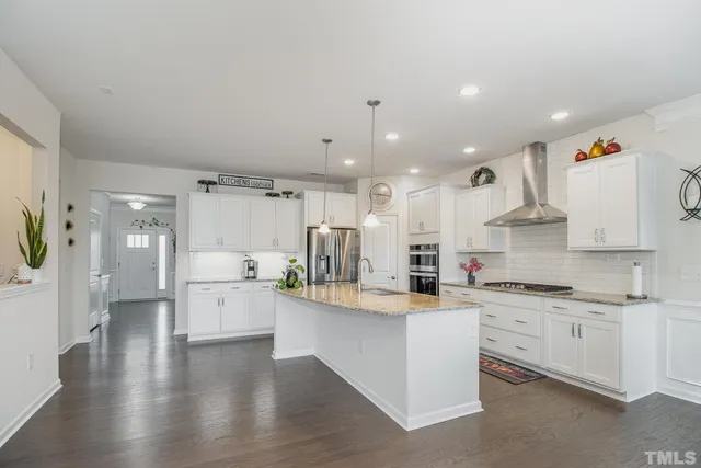 a kitchen with a sink stainless steel appliances and cabinets
