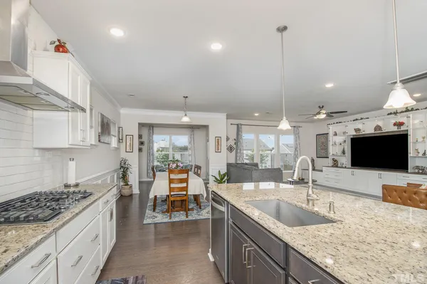 a kitchen with stainless steel appliances granite countertop a sink stove and cabinets