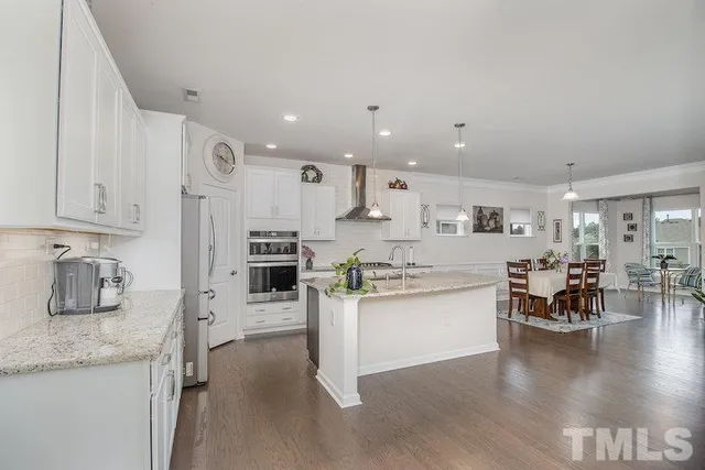 a kitchen with stainless steel appliances granite countertop a stove oven and a sink