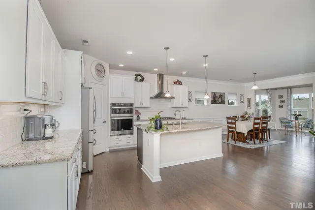 a kitchen with stainless steel appliances granite countertop a stove oven and a refrigerator