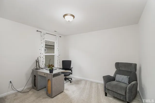 a view of livingroom with workspace and a couch