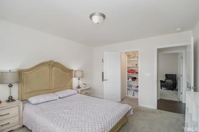 a bedroom with a large bed and a couch