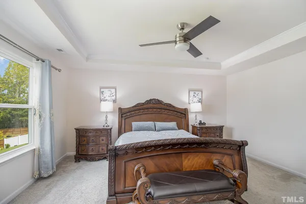a view of bedroom with furniture and a window