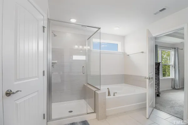 a bathroom with a bathtub and a shower