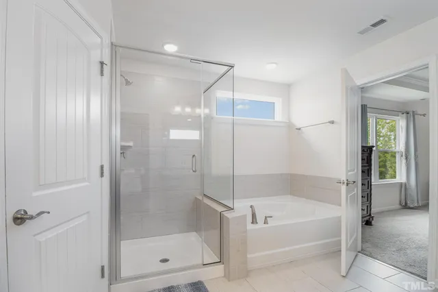 a bathroom with a bathtub and a shower