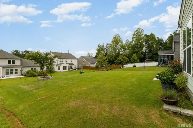 a front view of a house with a big yard