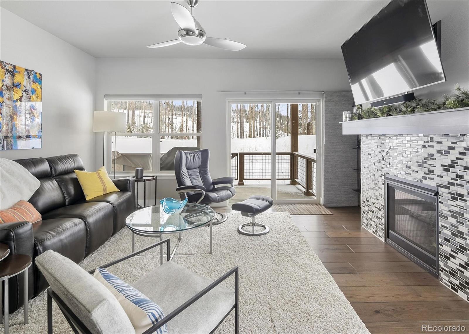 77 High Grove Loop Winter Park, CO 80482 - Photo 2 of 14 a living room with furniture a fireplace and a flat screen tv