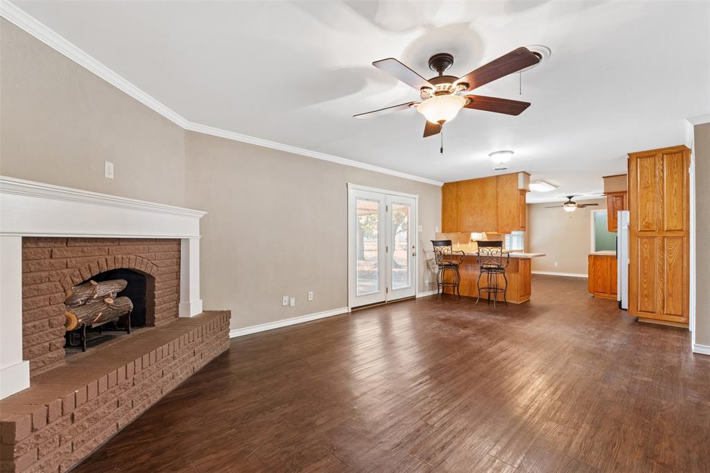 913 North Main Street Springtown, TX 76082 - Photo 12 of 40 a living room with furniture and a fireplace