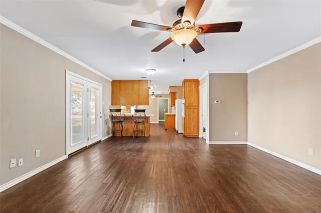 a kitchen with stainless steel appliances granite countertop a sink dishwasher stove and refrigerator with wooden floor