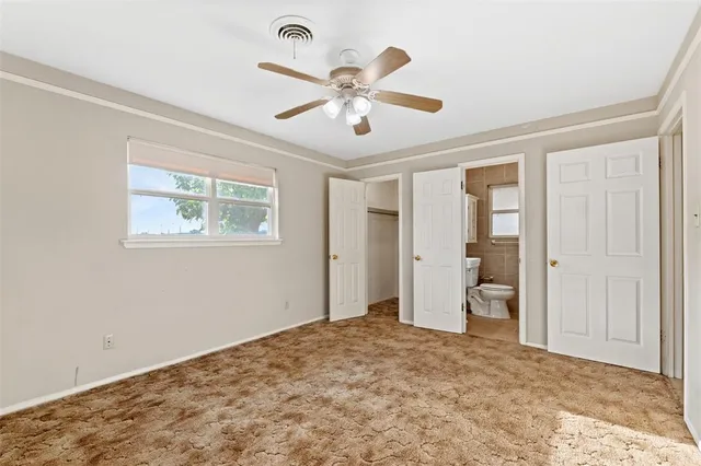 a view of a livingroom with a ceiling fan & a ceiling fan