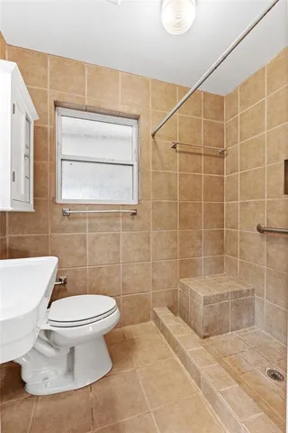 a bathroom with a toilet and a shower