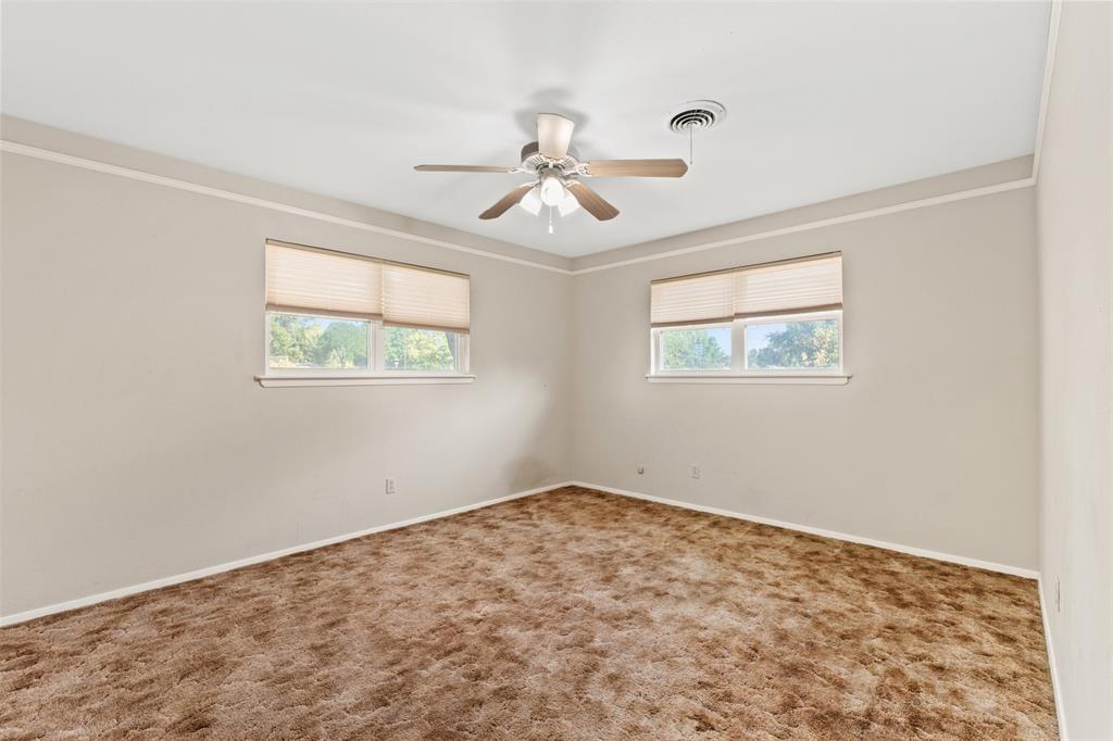 913 North Main Street Springtown, TX 76082 - Photo 24 of 40 a view of a big room with wooden floor and windows