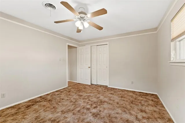 a view of a big room with wooden floor and windows in a room