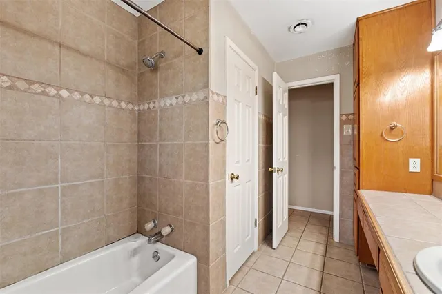 a bathroom with a tub a sink and shower