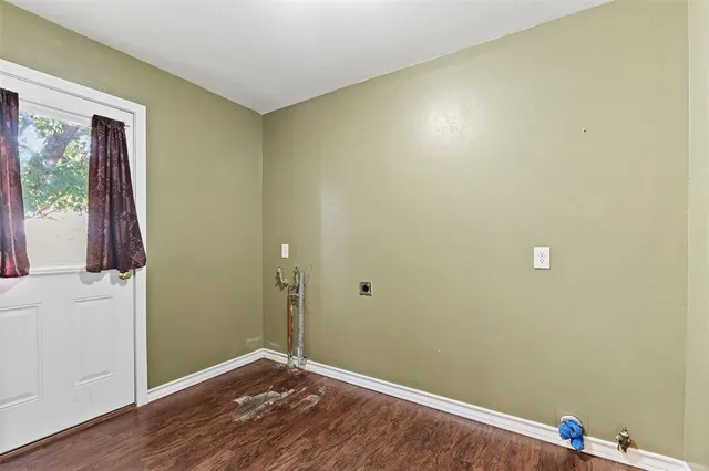 a view of room with window and wooden floor