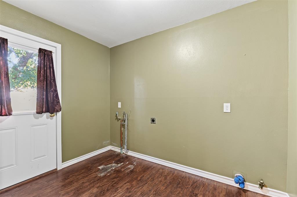 913 North Main Street Springtown, TX 76082 - Photo 30 of 40 a view of room with window and wooden floor