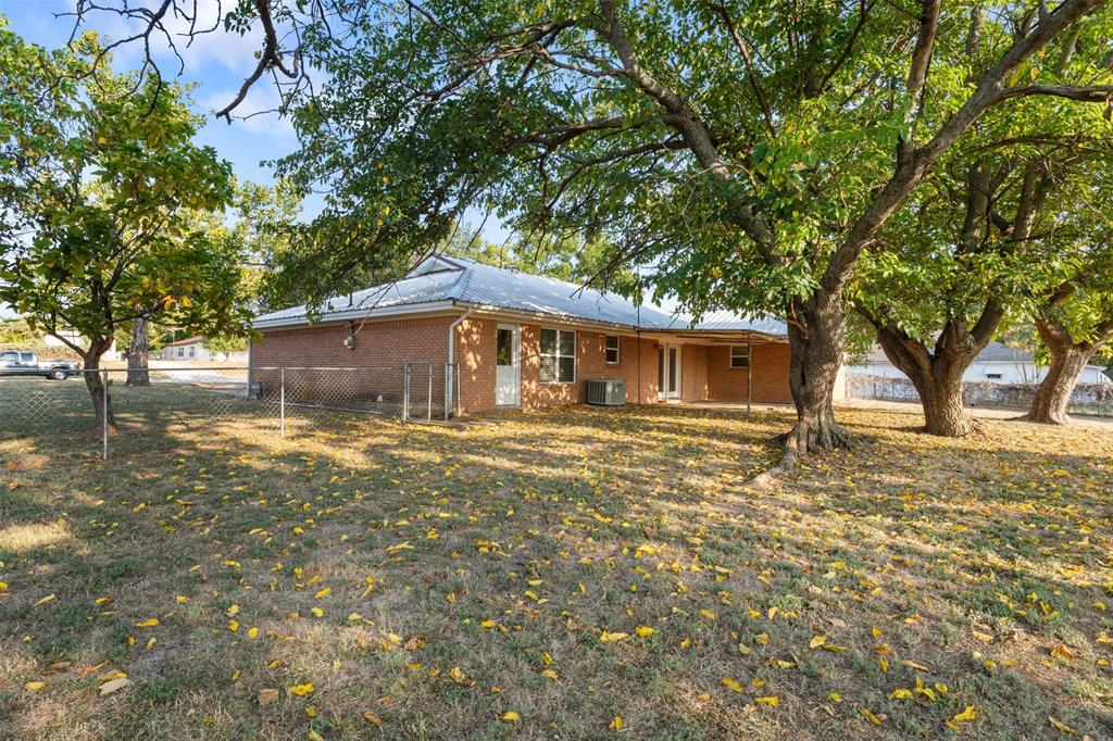 913 North Main Street Springtown, TX 76082 - Photo 35 of 40 a front view of a house with a garden