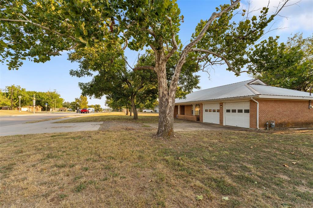 913 North Main Street Springtown, TX 76082 - Photo 38 of 40 a view of house covered with trees in front of it