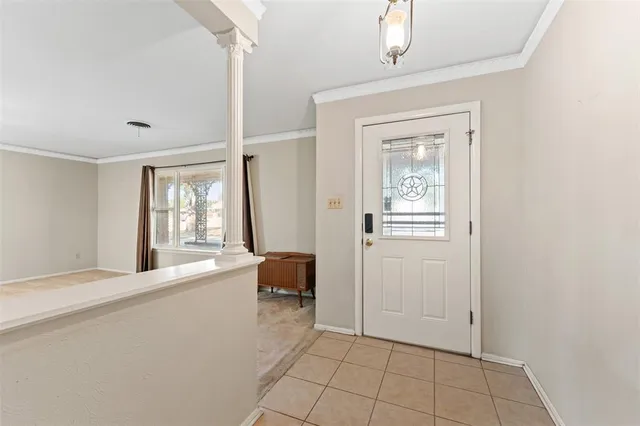 an empty room with a windows and ceiling fan