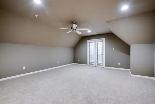 a view of an empty room with a ceiling fan