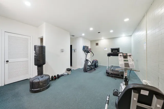 a room with gym equipment and a flat screen tv