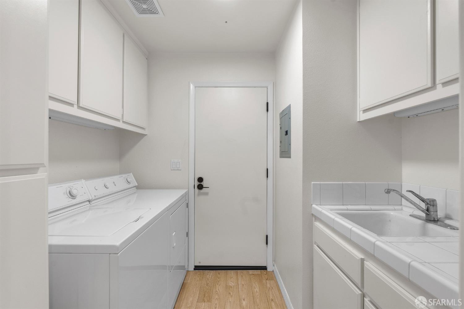 624 Sunflower Court San Ramon, CA 94582 - Photo 17 of 21 a utility room with cabinets washer and dryer