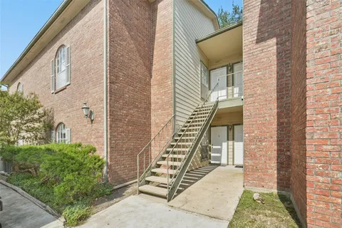a view of front door of house with stairs