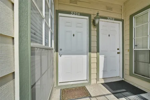 a view of a room with wooden floor and white walls