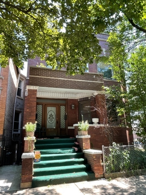3159 South Lowe Avenue, Unit 1F Chicago, IL 60616 - Photo 1 of 1 a front view of a house with a garden