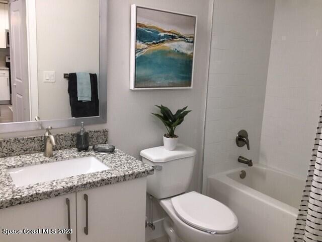 2755 Bosque Circle, Unit 302 Melbourne, FL 32940 - Photo 12 of 18 a bathroom with a granite countertop sink a toilet and bathtub