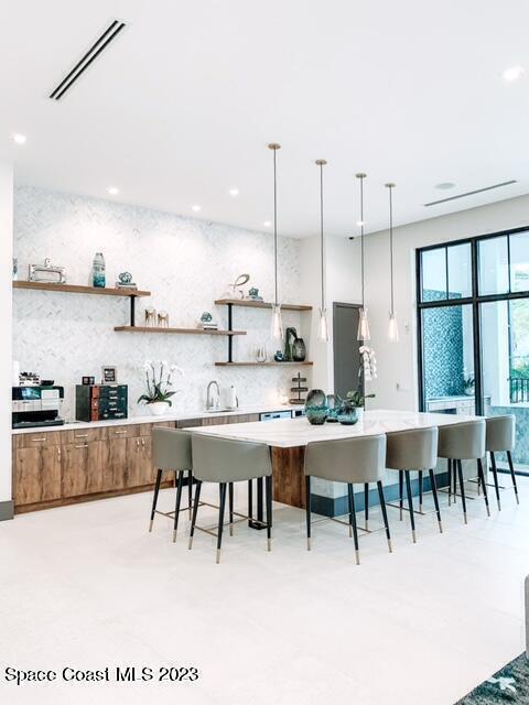 2755 Bosque Circle, Unit 302 Melbourne, FL 32940 - Photo 14 of 18 a view of kitchen with stainless steel appliances kitchen island a dining table chairs and sink