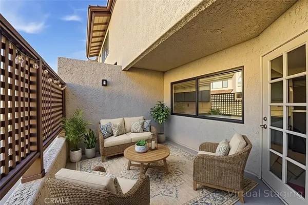a view of a patio with table and chairs and wooden fence