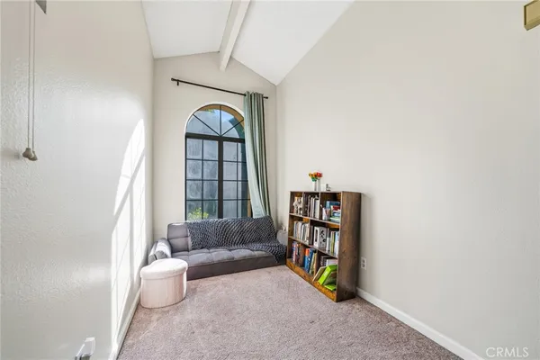 a bedroom with a bed and a lamp