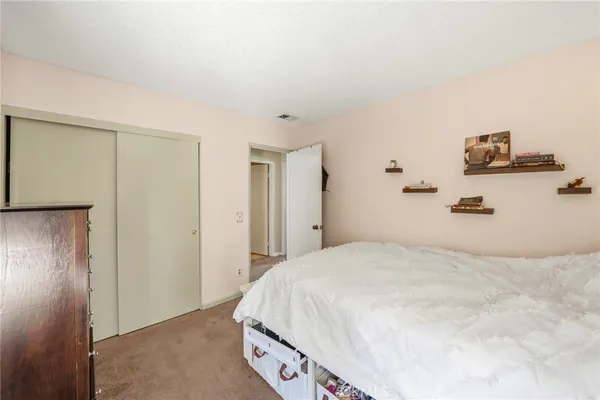 a bedroom with a bed and a dresser