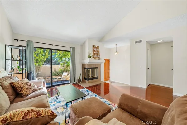 a living room with furniture and a fireplace