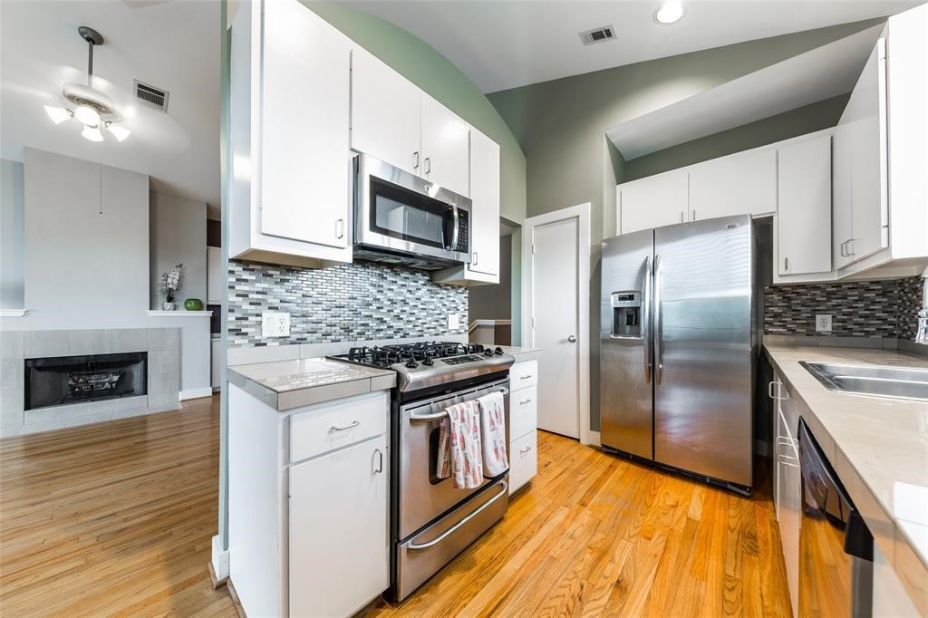 3027 Buttercup Street Houston, TX 77063 - Photo 11 of 29 a kitchen with stainless steel appliances granite countertop a stove a refrigerator and a microwave