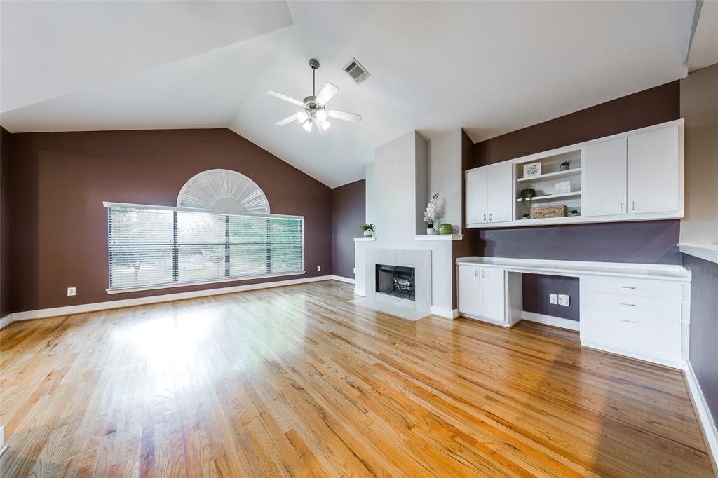 3027 Buttercup Street Houston, TX 77063 - Photo 2 of 29 a view of an empty room with wooden floor fireplace and a window