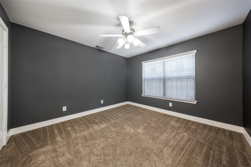 3027 Buttercup Street Houston, TX 77063 - Photo 23 of 29 an empty room with chandelier fan and windows