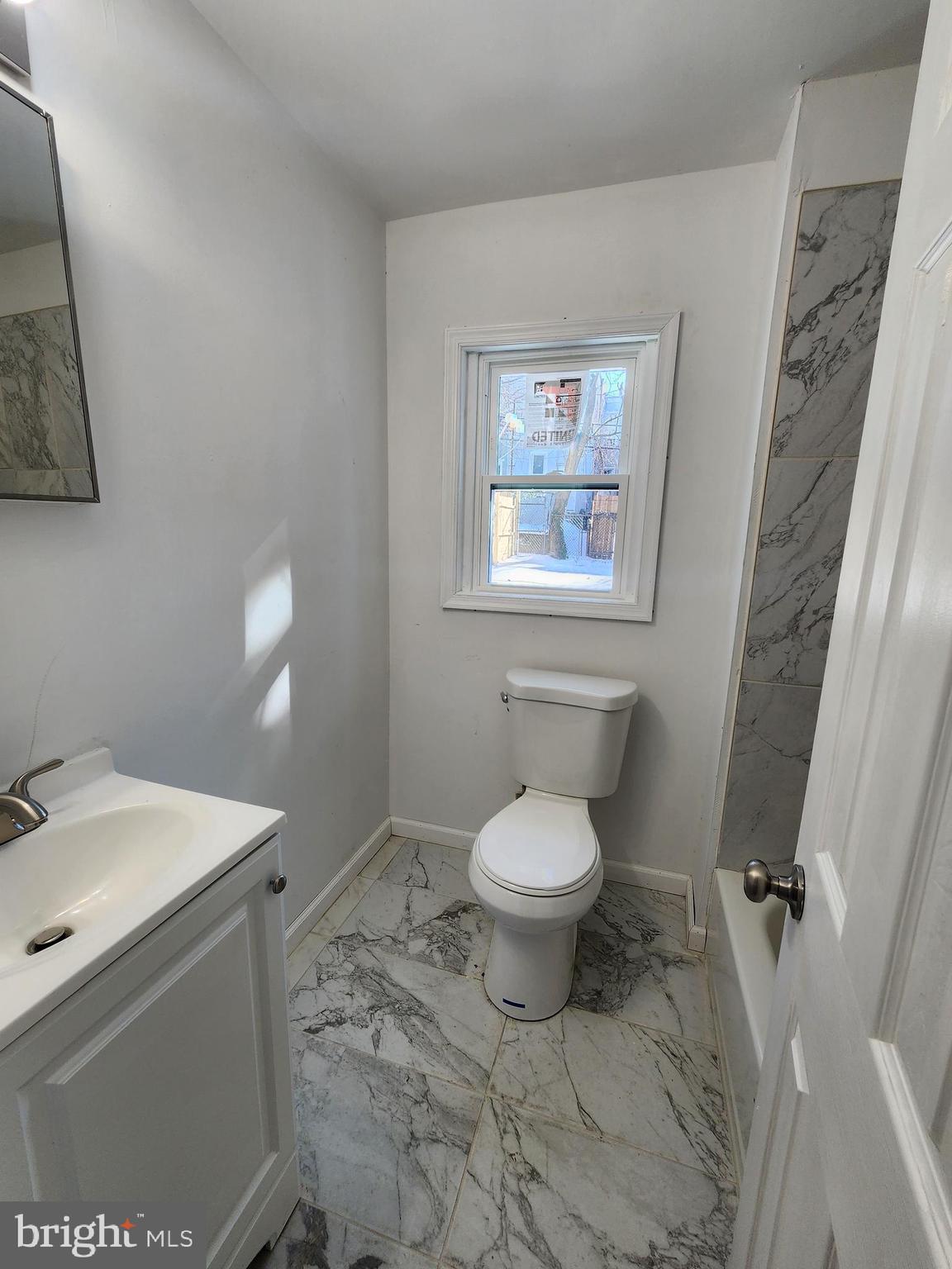 6616 Leeds Street Philadelphia, PA 19151 - Photo 12 of 29 a bathroom with a toilet sink and vanity