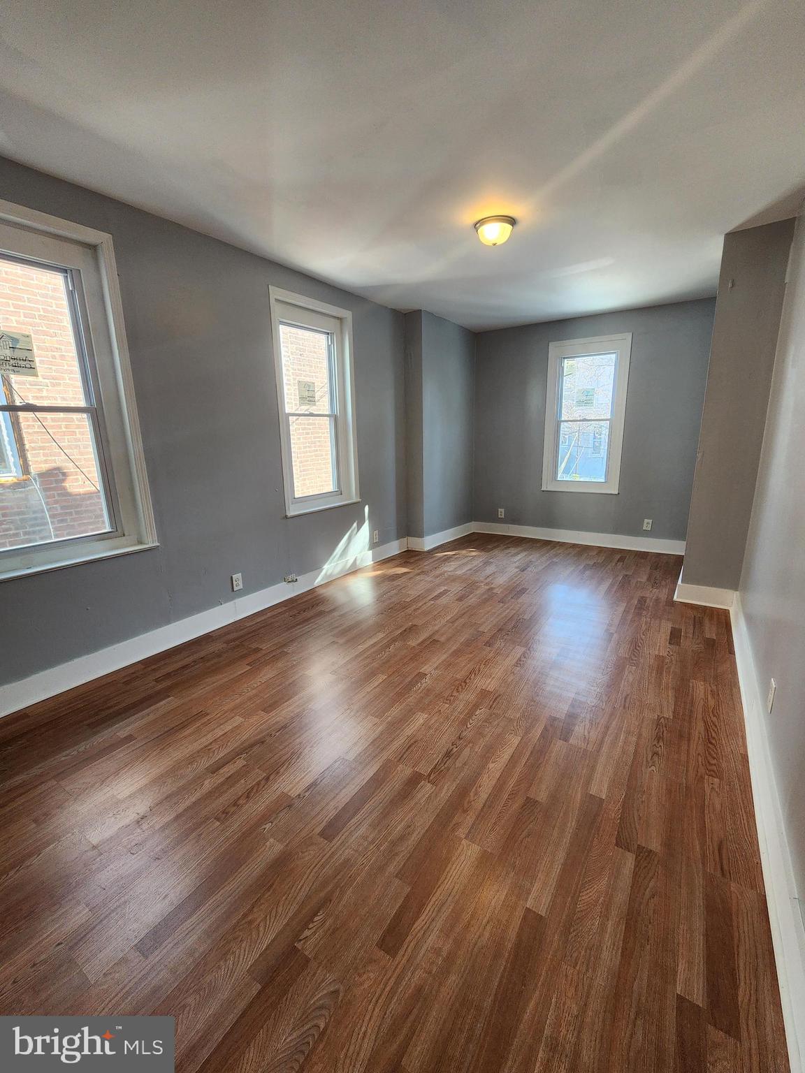 6616 Leeds Street Philadelphia, PA 19151 - Photo 19 of 29 an empty room with wooden floor and windows