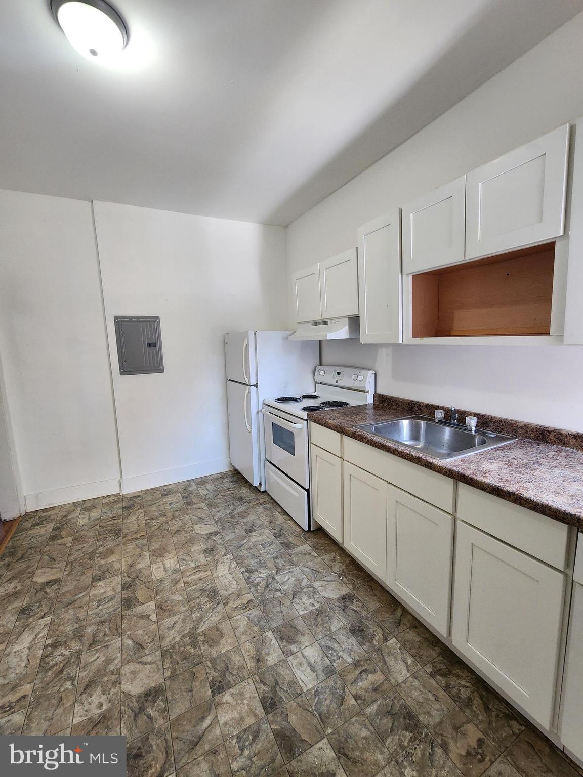 6616 Leeds Street Philadelphia, PA 19151 - Photo 21 of 29 a kitchen with stainless steel appliances granite countertop a sink and a stove