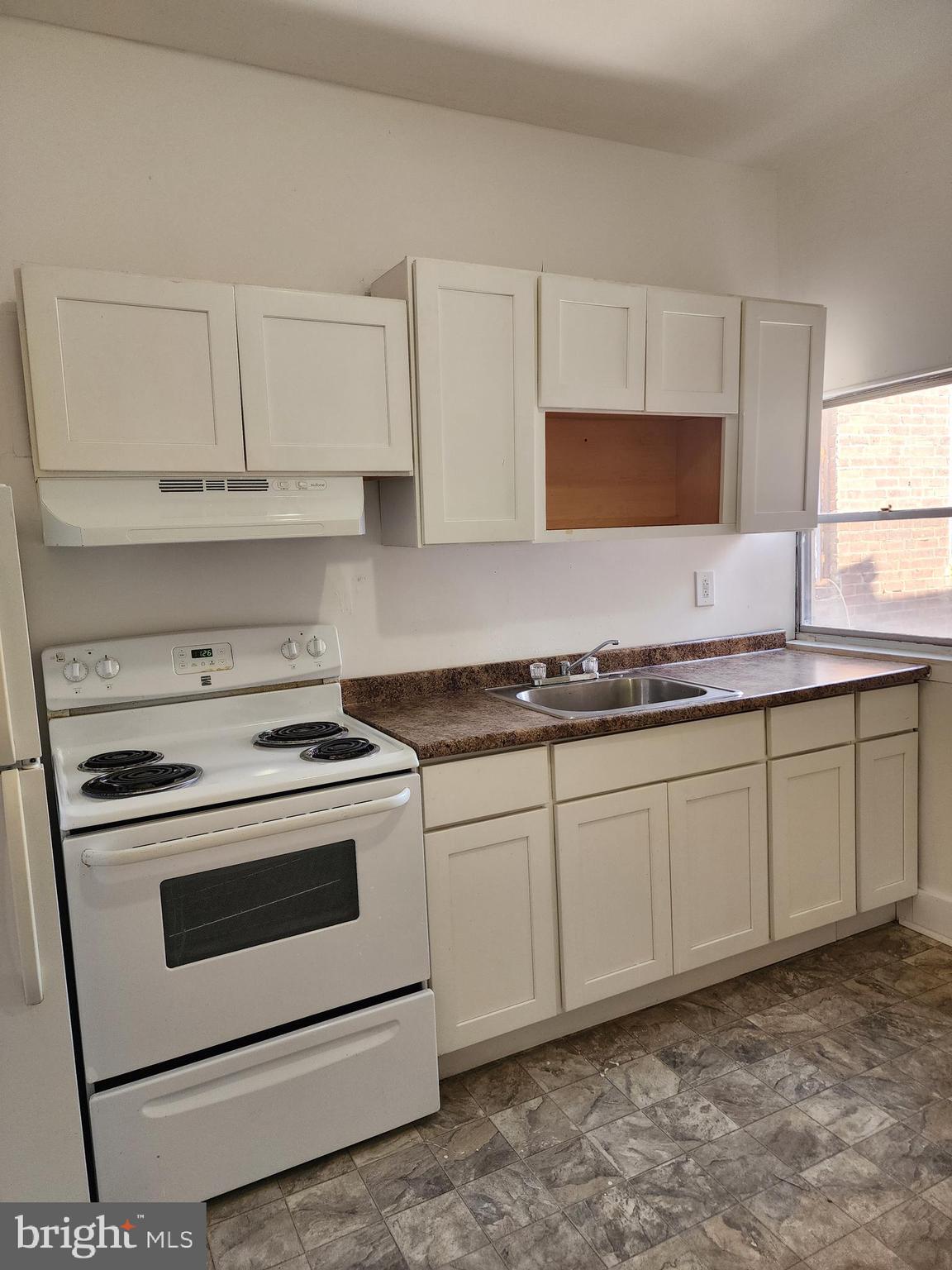 6616 Leeds Street Philadelphia, PA 19151 - Photo 23 of 29 a kitchen with granite countertop cabinets stainless steel appliances and a sink