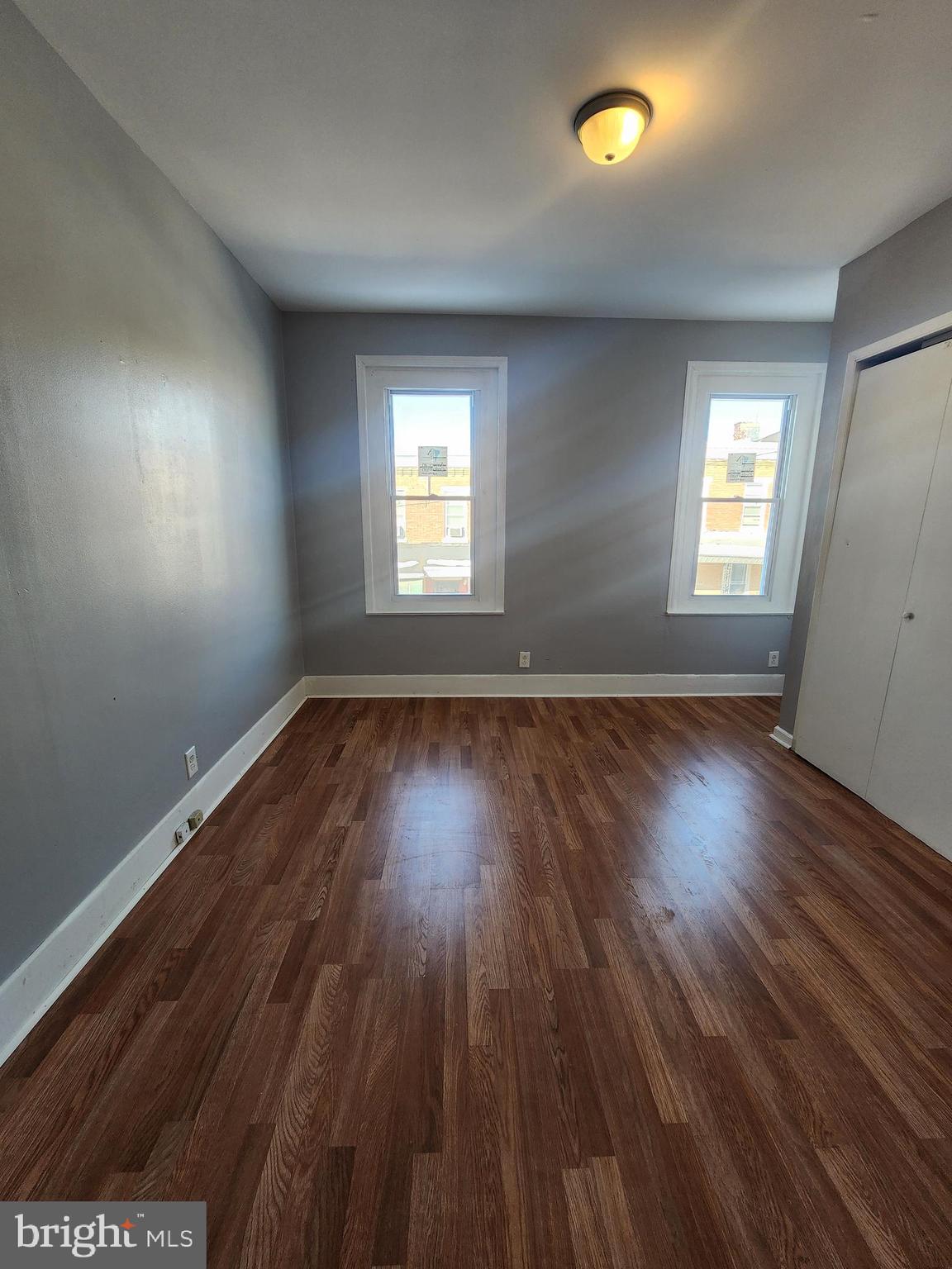 6616 Leeds Street Philadelphia, PA 19151 - Photo 26 of 29 an empty room with wooden floor and windows