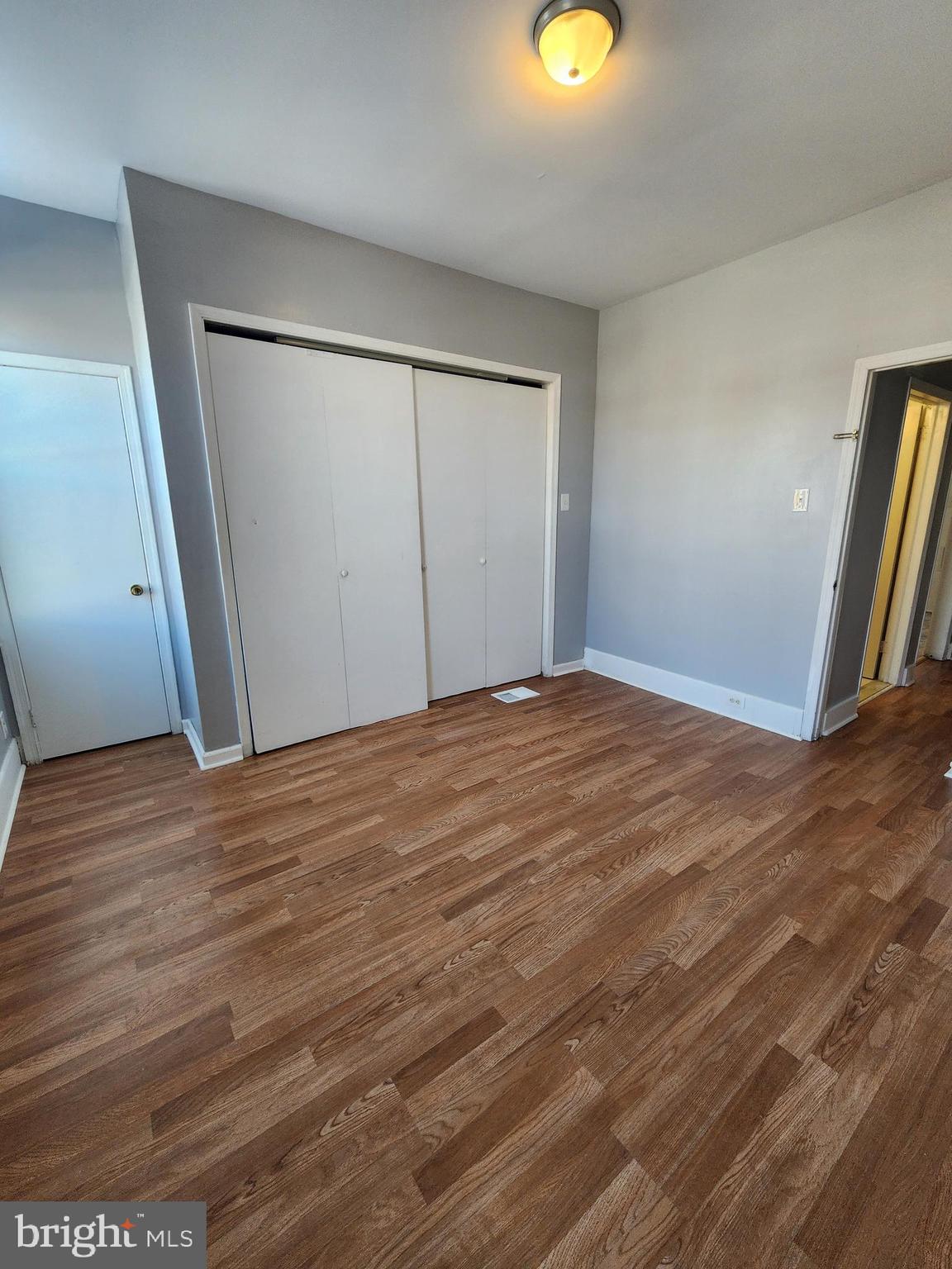 6616 Leeds Street Philadelphia, PA 19151 - Photo 27 of 29 an empty room with wooden floor and closet