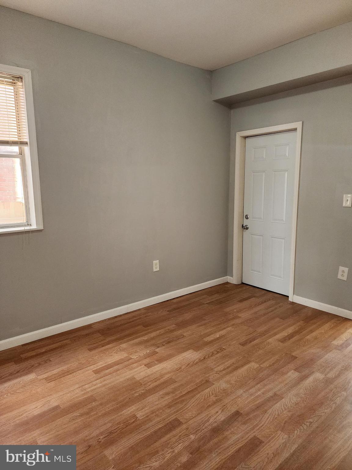 6616 Leeds Street Philadelphia, PA 19151 - Photo 9 of 29 a view of an empty room with wooden floor and a window