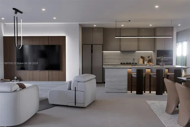 a living room with stainless steel appliances kitchen island a table and a couch