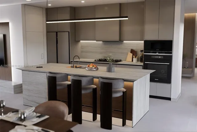 a kitchen with stainless steel appliances granite countertop a stove a sink and a refrigerator