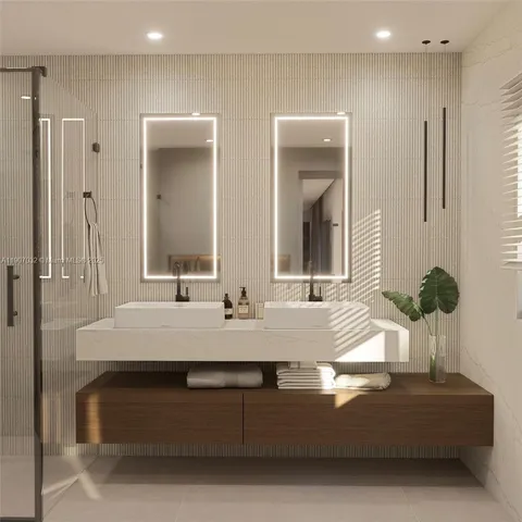 a bathroom with double vanity sinks and a mirror